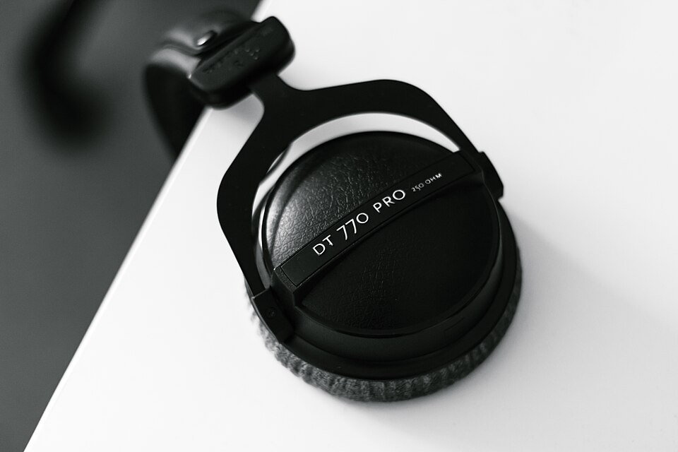 Beyerdynamic DT 770 Pro headphones hanging from a desk